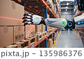 A humanoid robot that recognizes and picks out packages with JAN codes from shelves in a warehouse where cardboard boxes are piled up. 135986376