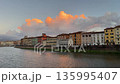 Sunset over the river Arno in Pisa city, Tuscany, Italy. 135995407