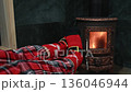 Feet in Christmas socks warming by fireplace, person relaxing by stove 136046944