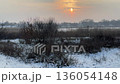 Sunset over the snow covered river at winter. 136054148