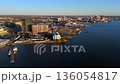 Riverside urban landscape with modern docks and wide river aerial view 136054817