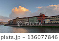 Colorful densely packed residential buildings line the River Arno in Pisa, Italy, Tuscany, picturesque feature of the city's waterfront, often referred to as the Lungarno.  136077846