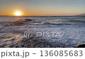 Sunset over sea in Liguria. Sunny weather in evening. Background for design. Concrete steps on beach. 136085683