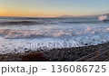 Storm at sea. Waves and shore with stone breakwater, sunny weather in the evening. Sunset season in Liguria. Background for design.  136086725