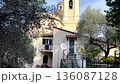 View of church and olive trees from mountain. Nature, traditional town, buildings of Liguria. Architecture and structures in Italy. Points of interest along hiking route in Sestri Levante.  136087128