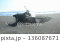 A Chihuahua-style dog rolling around on the sand at Shonan Beach 136087671