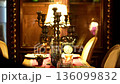 Vintage restaurant table set with candles and warm lighting 136099832
