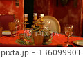 Cozy vintage restaurant table with golden candelabra on orange cloth 136099901