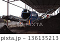 The equipment at the compost plant processes organic waste, and the ready-made stabilized organic fertilizer is sifted through a sieve, and a mixture for soil fertilization is produced 136135213