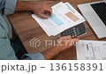 Adult man calculates total expenses examining utility bills, male family breadwinner conducts analysis of household expenditures summarizing financial data slow motion 136158391