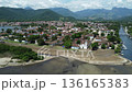 Aerial pan over Paraty with the river and the Atlantic Forest and mountains 136165383