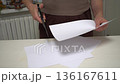 Scissors cutting white sheets of paper close-up 136167611
