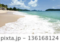 Waves crash on a sandy beach under a blue sky at Tengah Beach. Langkawi Island. Malaysia 136168124
