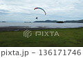 Motorised paraglider taking of from a tropical beach in Paraty in Brazil 136171746