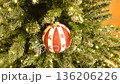 A painted Christmas tree ornament featuring snowflakes and reindeer. It evokes a Christmas fairy tale and creates a joyful mood. A perfect gift or home decoration. 136206226