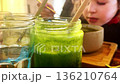 Child eating green vegetable soup 136210764