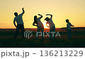 Dad Mom, kids daughter do fitness exercises together at sunset. People are training in meadow. Sporty family trains in park summer. Active healthy lifestyle in nature. Family team parents and children 136213229
