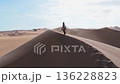 Woman Ascending Sand Dunes in Peru 136228823