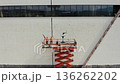 Mural artists painting a building facade 136262202