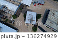 Aerial View of Industrial Complex Featuring Rows of Tin Roofed Buildings  136274929