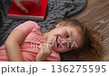 Top view of happy little Caucasian girl playing in living room on carpet. Happy family time. 136275595