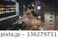 A bustling urban intersection at night with moving vehicles, glowing skyscrapers, and vibrant street lights enhancing the lively cityscape. Time-lapse, Seoul, South Korea 136279731