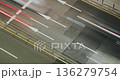 Vehicles traverse an urban street, highlighting the continuous flow of traffic with visible lane markings and blurred motion effects. Time-lapse, Seoul, South Korea 136279754