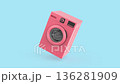 Modern pink washing machine on blue background 136281909