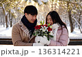 An Asian man and an Asian woman hold a flower bouquet 136314221