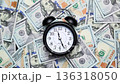Timelapse of black and white vintage alarm clock on dollar banknotes. 136318050