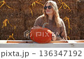 Pregnant woman holding pumpkin on farm outdoors 136347192