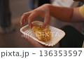 Hands holding sliced pizza al taglio in Rome street food takeaway 136353597