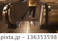 People walking on escalator in underground subway corridor in Rome 136353598