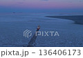 Ship navigates icy passage rapidly. Supply ship accelerates along icy route heading toward open ocean 136406173
