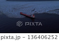 Drone views vast sea. Silhouetted ship navigates icy waters beneath muted winter sky in tranquil landscape 136406252