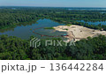 Aerial view of a river treatment facility. A treatment plant for cleaning the river bottom and removing sand on green river shore. Screening and washing in open-pit mining. Sand cleaning plant 136442284