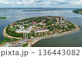 Drone aerial view of Sviyazhsk historic island town surrounded by Volga river with monasteries, churches and green landscape under blue sky and clouds 136443082