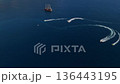 Aerial drone view of speedboats creating circular waves around pirate style tour ship in open sea. Summer travel, marine activity and adventure tourism concept on deep blue water 136443195