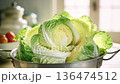 Fresh cabbage leaves in a metal colander, copy space, slow rotation 136474512