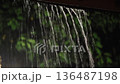 A tropical rainstorm at night on the villa's veranda 136487198