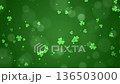 Abstract green shamrocks background with bokeh and floating particles for St. Patrick's Day. 136503000
