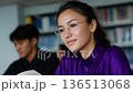 Young Woman Smiling Thoughtfully in Library Study Session 136513068
