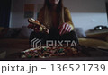 Woman Enjoys Pizza. Softly Lit Living Room Scene Captures Woman Enjoying Warm Pizza Slice Alone 136521739