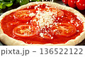 Super slow motion close-up of grated mozzarella falling onto fresh pizza with tomato sauce and sliced tomatoes. Detailed texture, flying cheese particles. Concept of pizza preparation and cooking. 136522122