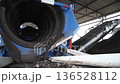 The equipment at the compost plant processes organic waste, and the ready-made stabilized organic fertilizer is sifted through a sieve, and a mixture for soil fertilization is produced. The tractor 136528112