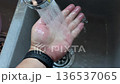 Closeup washing hand at sink in the kitchen 136537065
