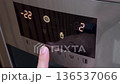 Man hand pressing button on refrigerator for ice 136537066