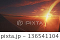 Dramatic sunset with light rays over airplane wing view Dramatic sunset with light rays over airplane wing view 136541104