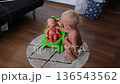 A 2 or 3 year old child sits a doll on the potty, a concept for potty training and weaning. High quality 4k footage 136543562