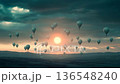 Barren land awakens as hot air balloons rise with the sun 136548240